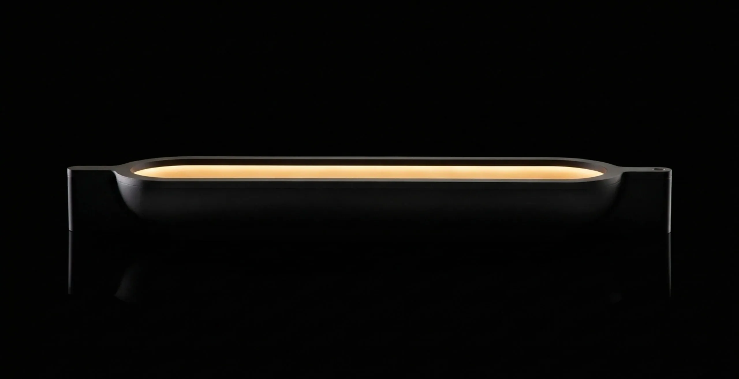 A Vessel Lamp in brass glowing in the dark