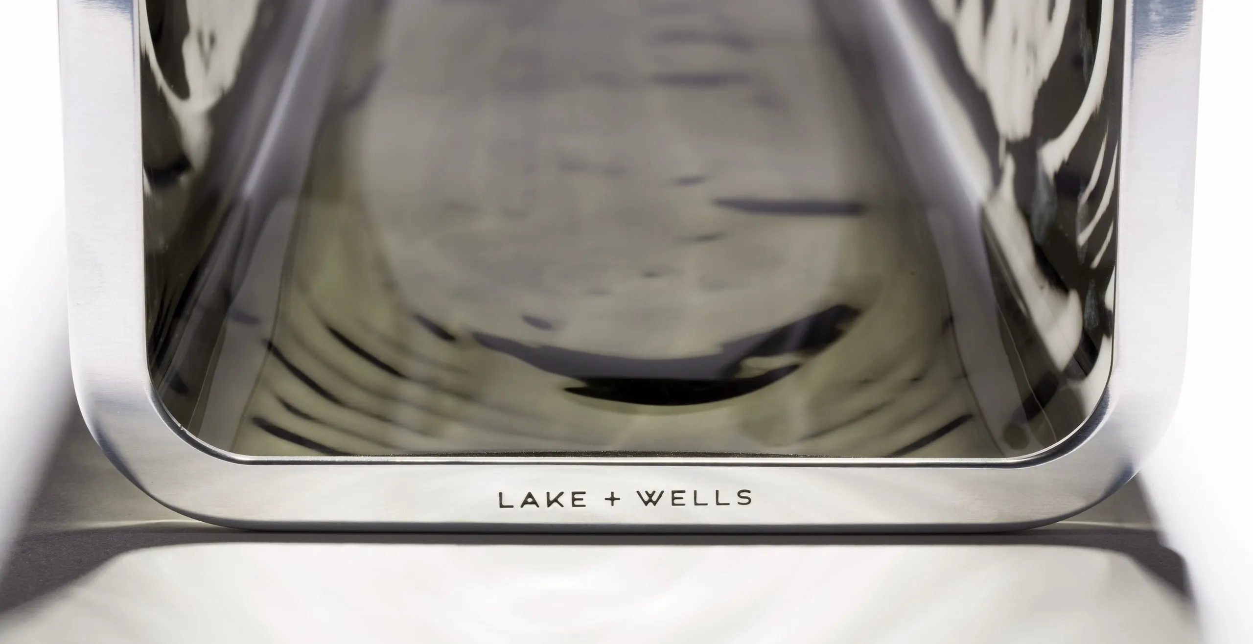 A Faaro glass form on its polished steel base, engraved Lake + Wells
