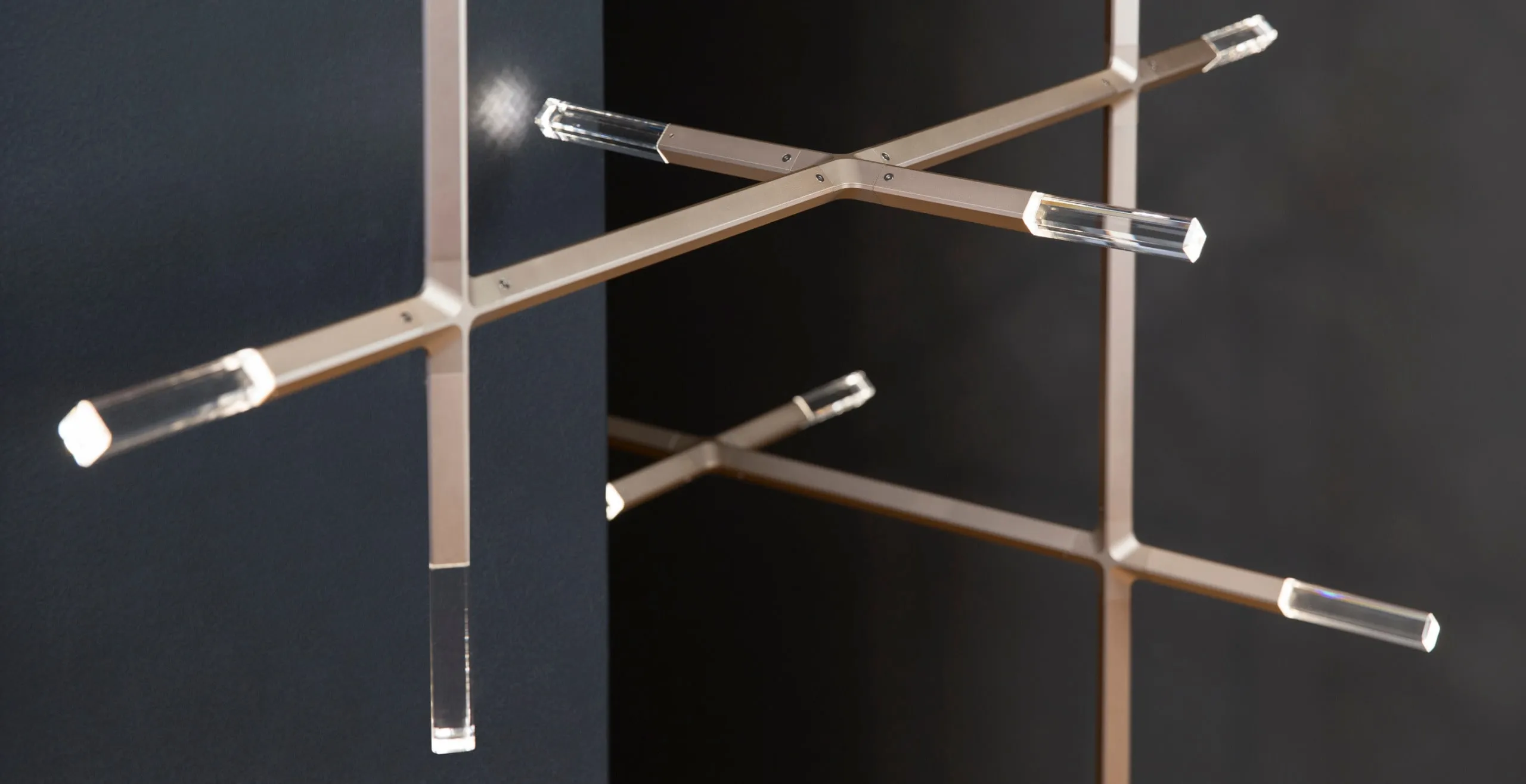 JAX Edition arms with crystal tips crossing in front of a dark wall