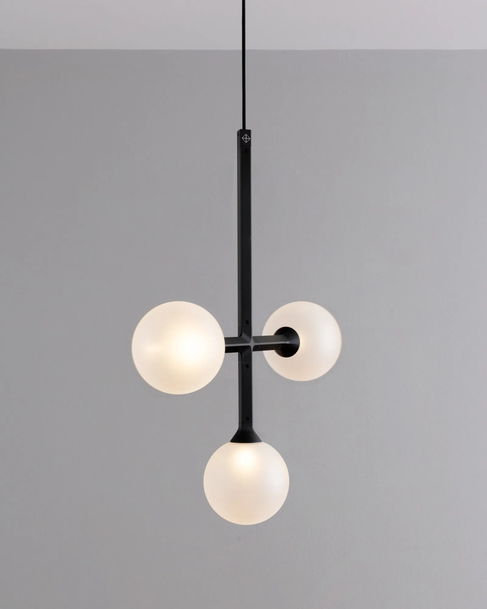 A JUNIP pendant in the studio: one crossbar of globes and a globe below