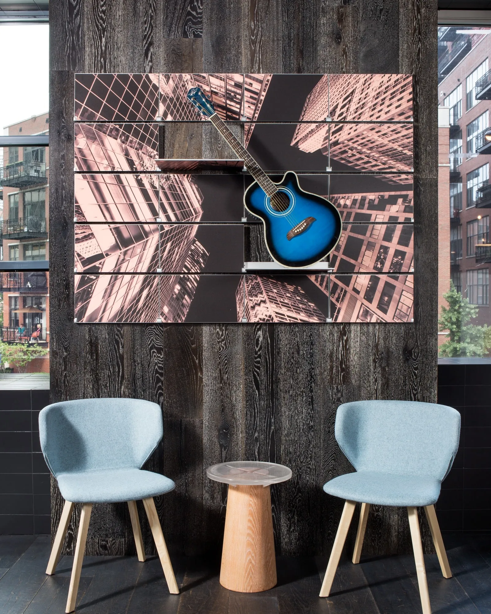 Riveli Art Shelves printed with a city view and a guitar, above two chairs and a small table