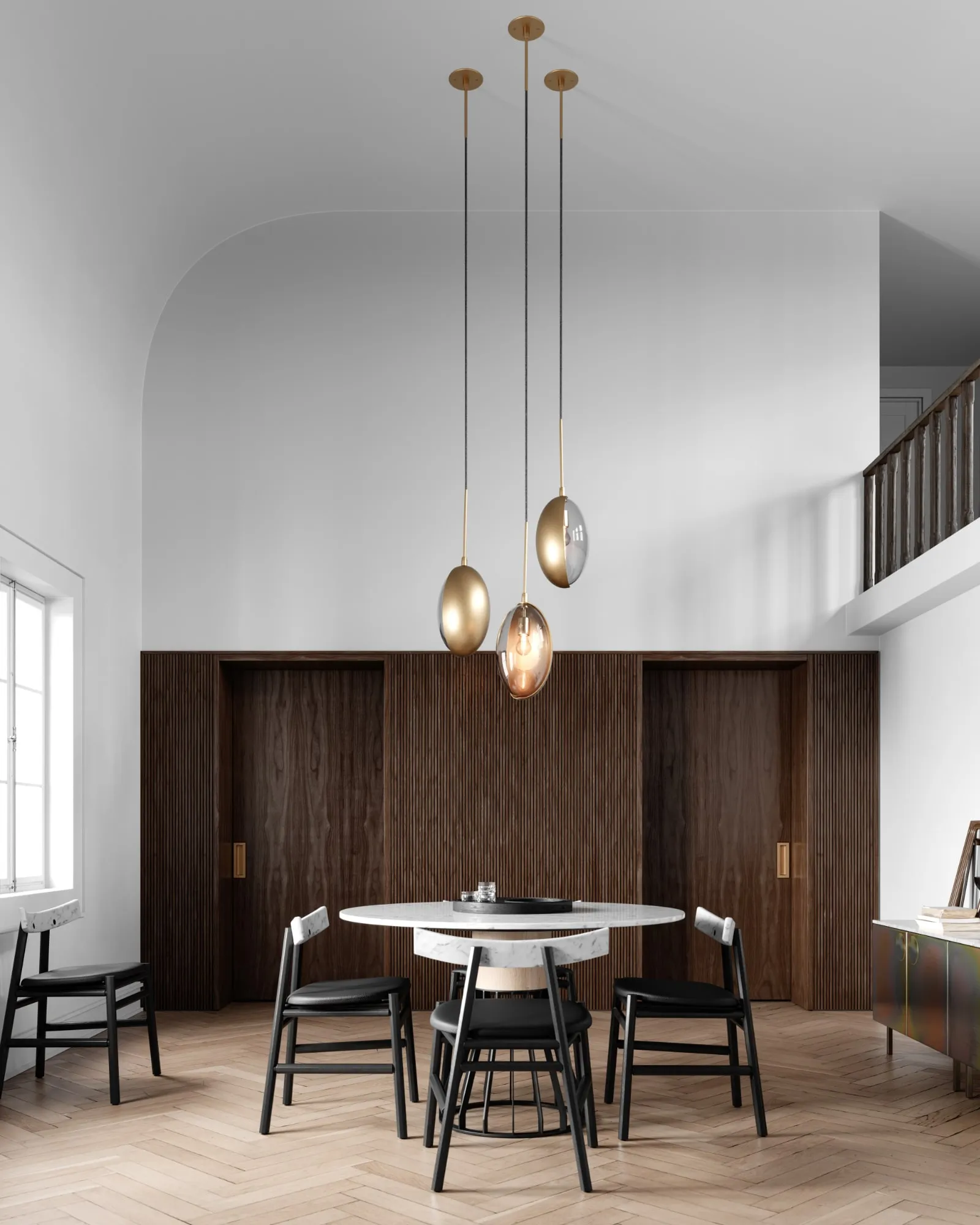 Three Oona pendants over a round dining table in a double-height room