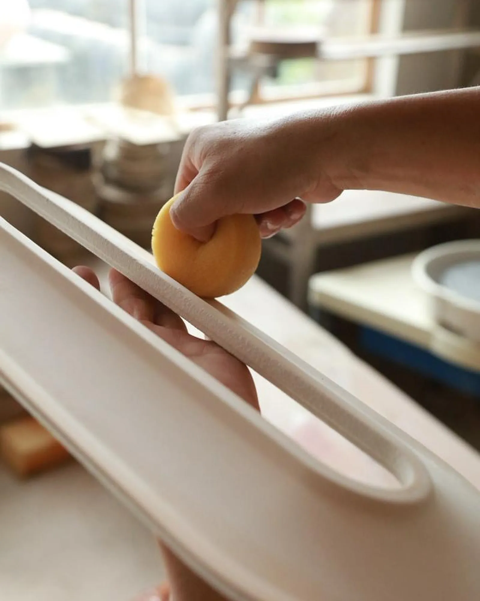 Shaping a Void Ceramic Sconce by hand in the studio