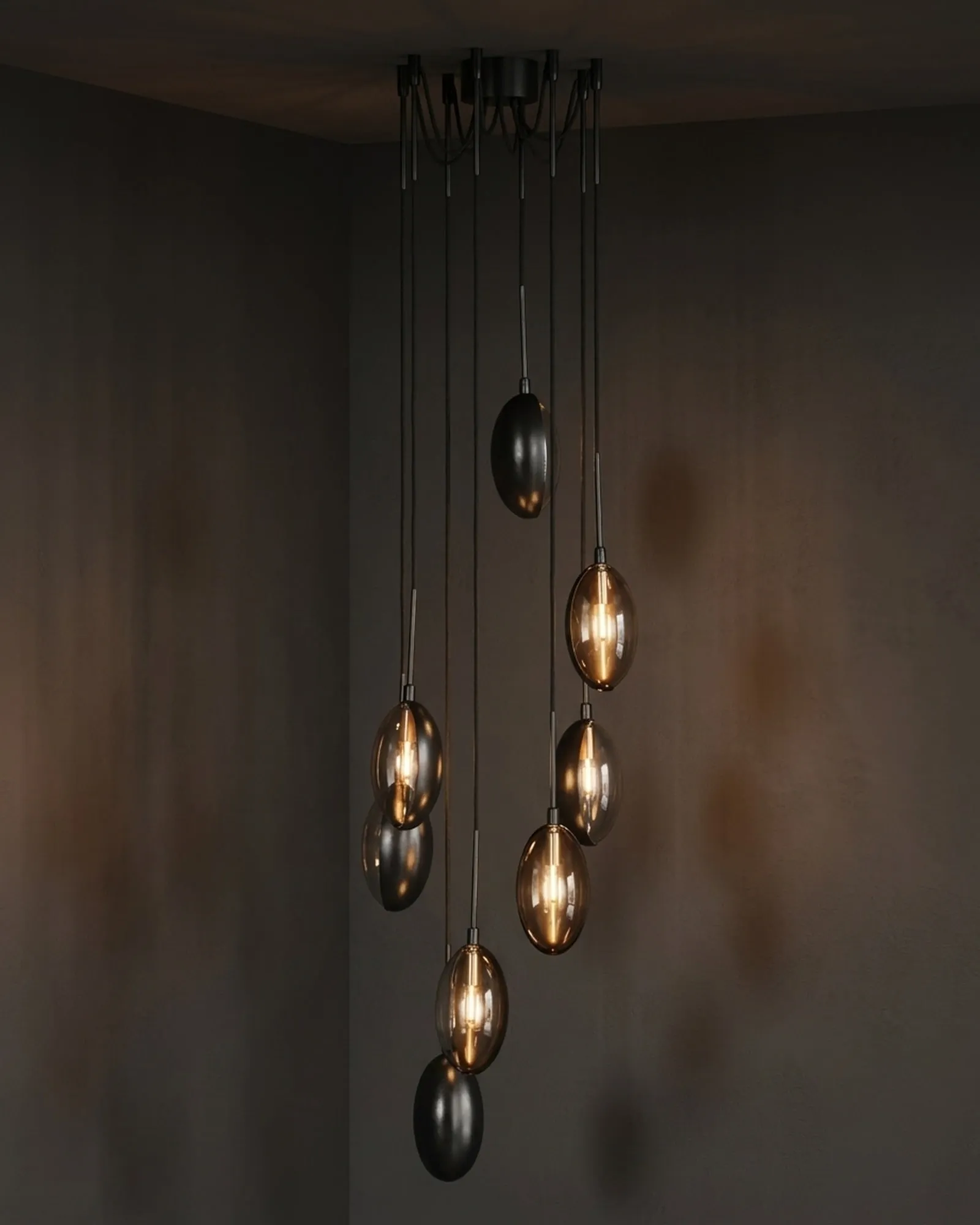 An Oona chandelier of eight pendants at staggered heights, lit