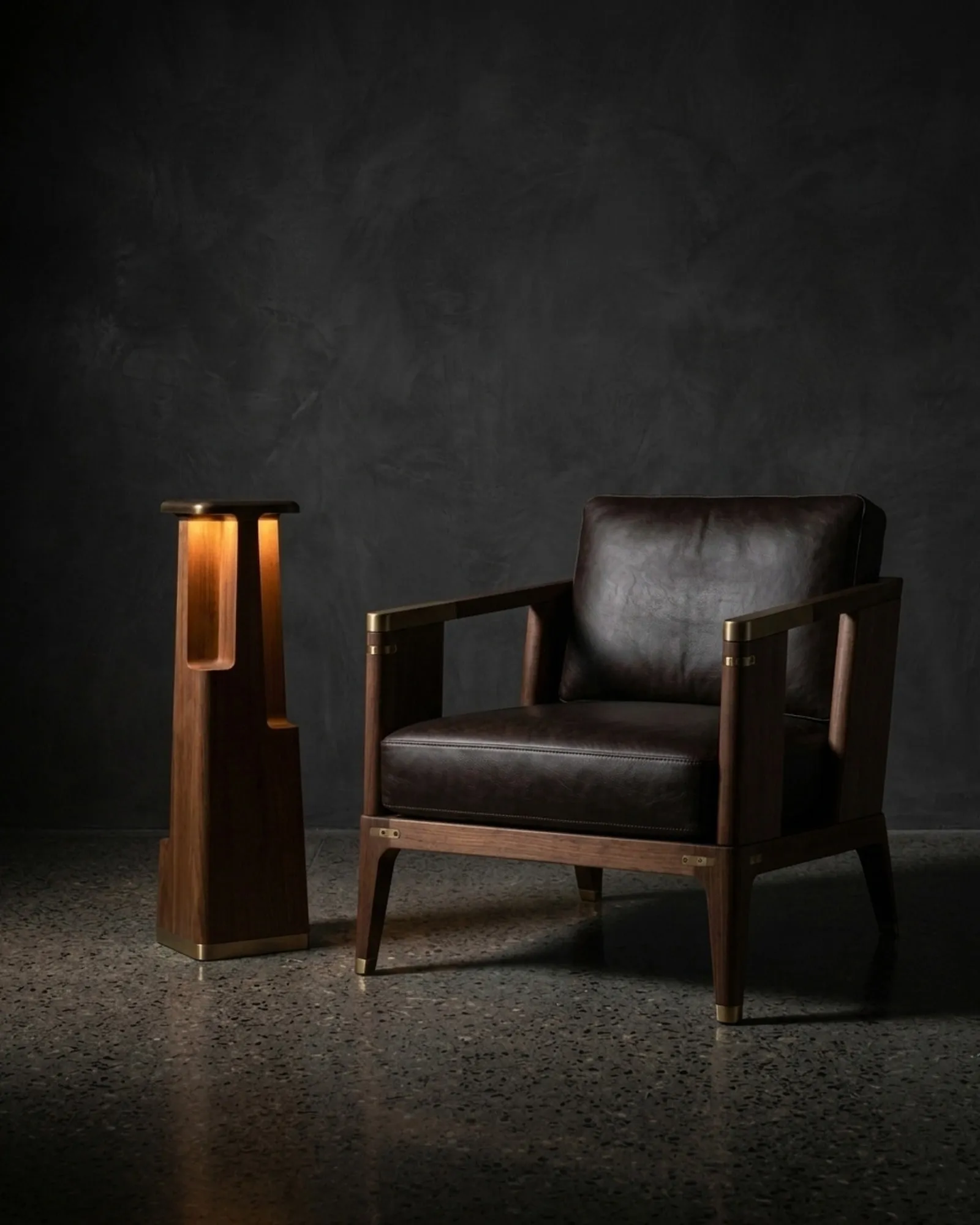 A Totem Floor Lamp in teak beside a leather armchair