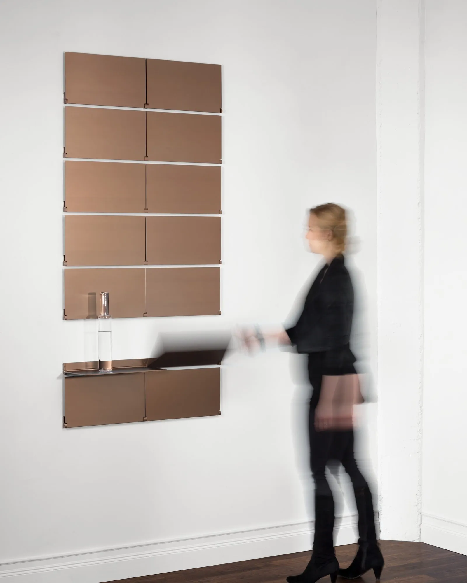 Riveli Luxe Shelves in Aged Bronze on a tall column, shelf up, then folded down on hover