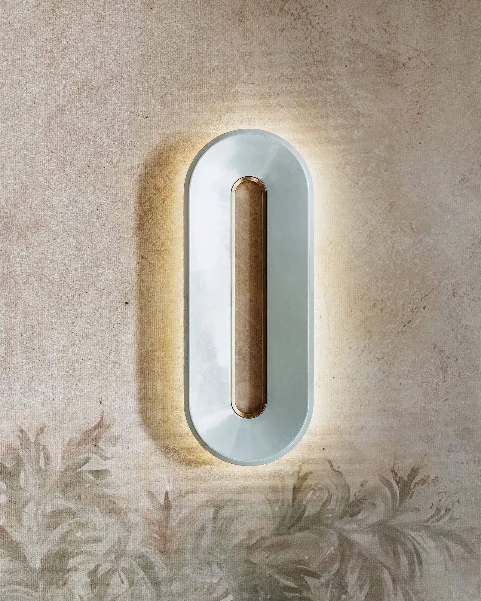Void Ceramic Sconce glowing on a painted wall