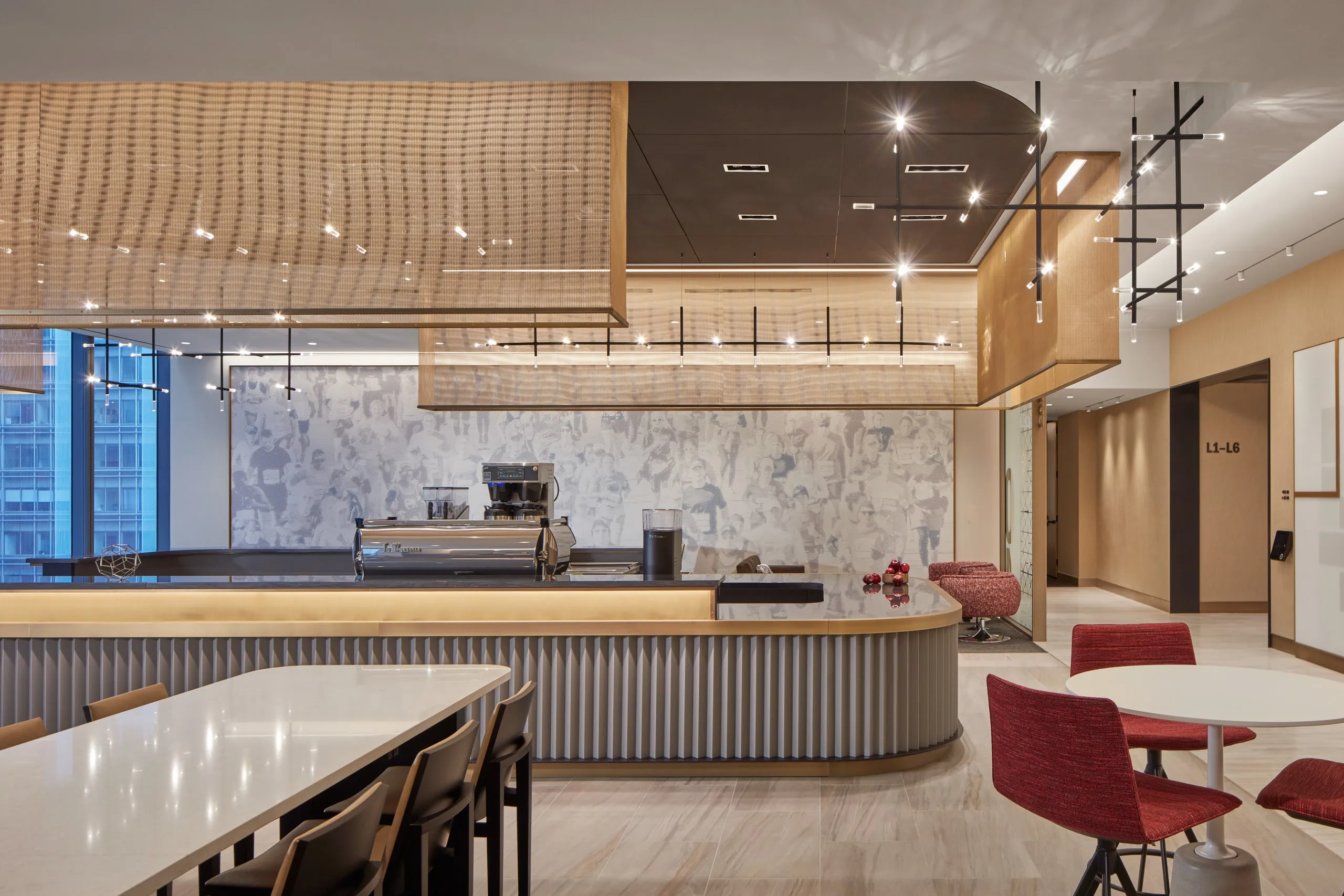 JAX fixtures over the counter of a café with red chairs