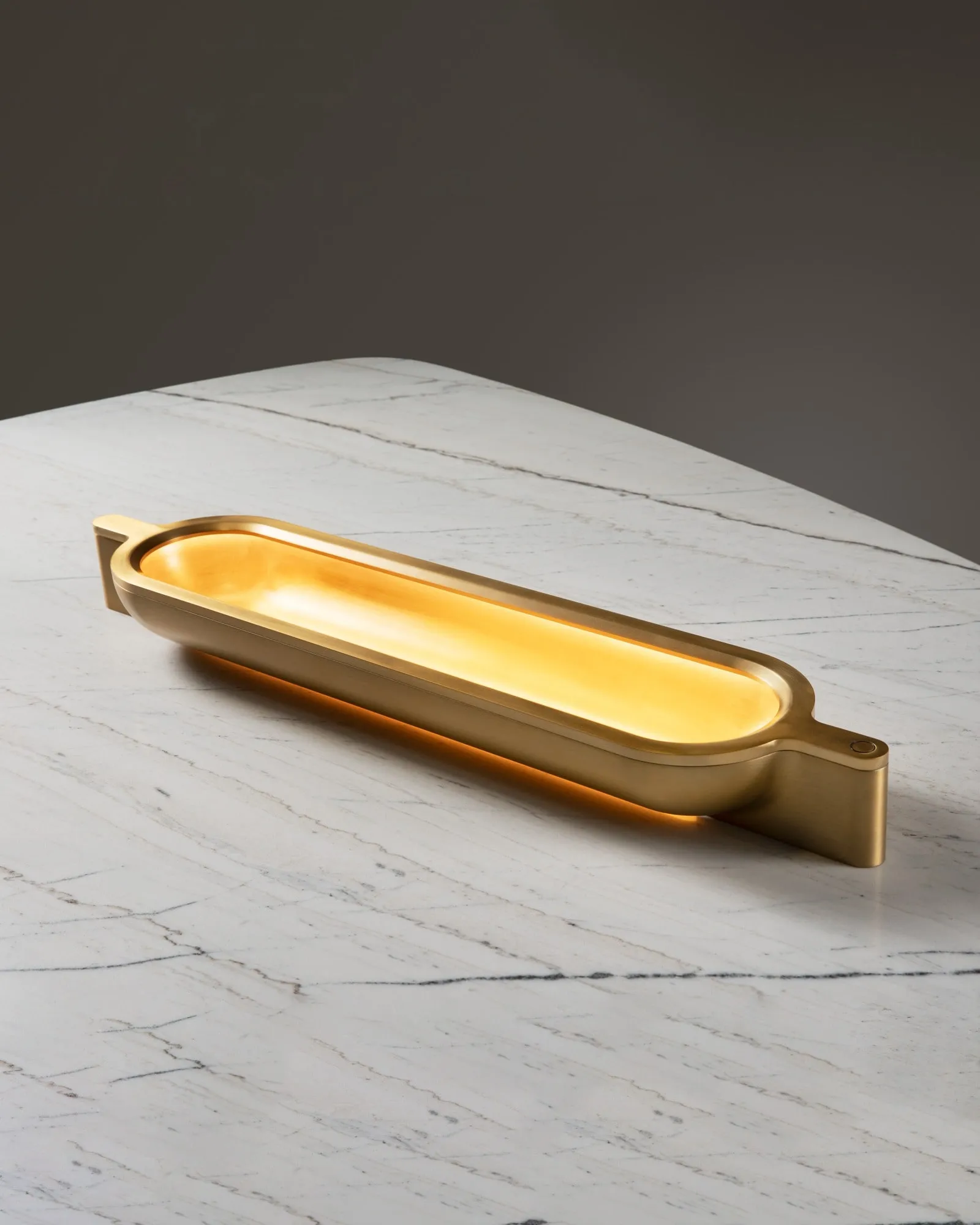 A Vessel Lamp in brass on a marble table