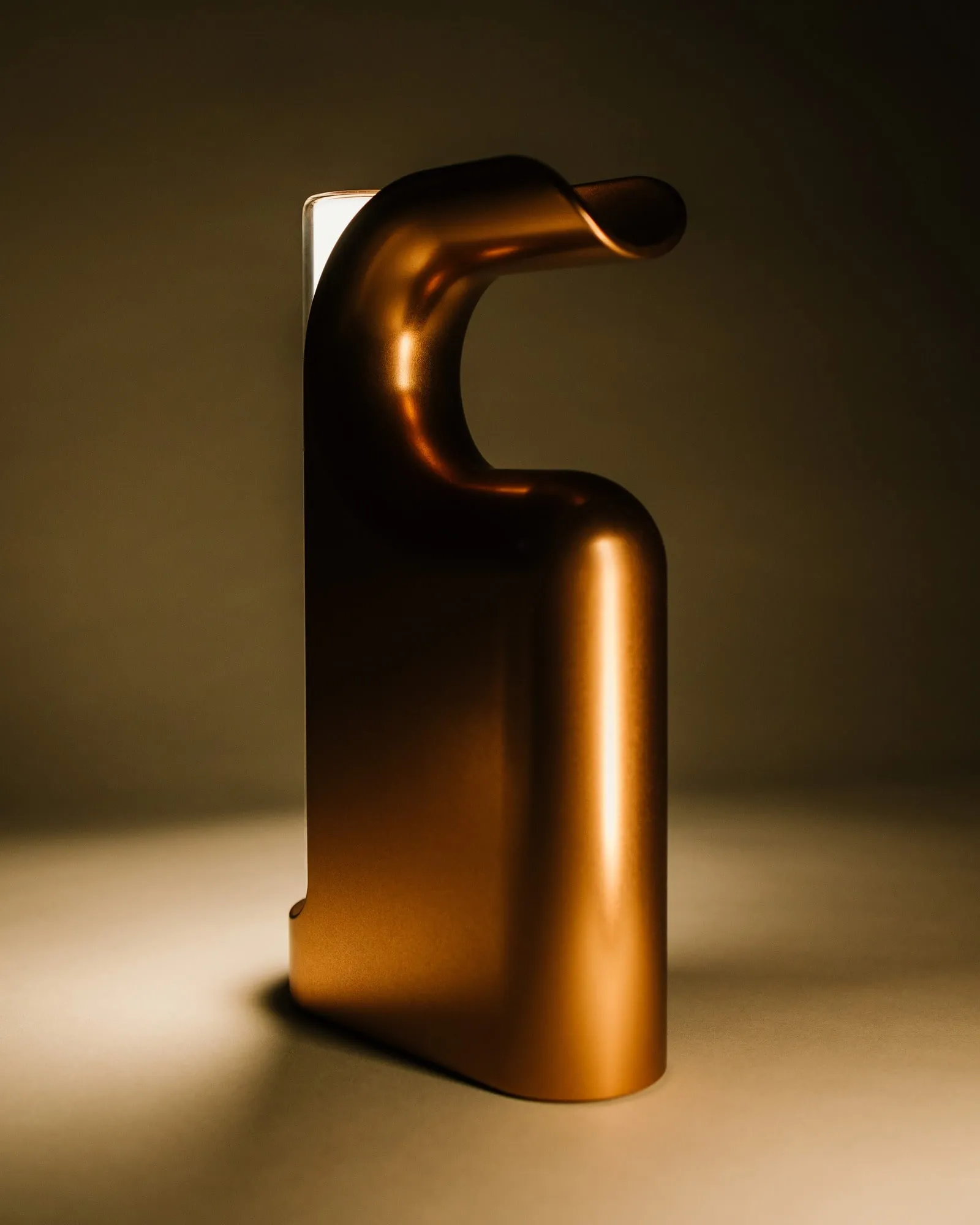 A Fable Lantern in bronze from the back, its light on the floor