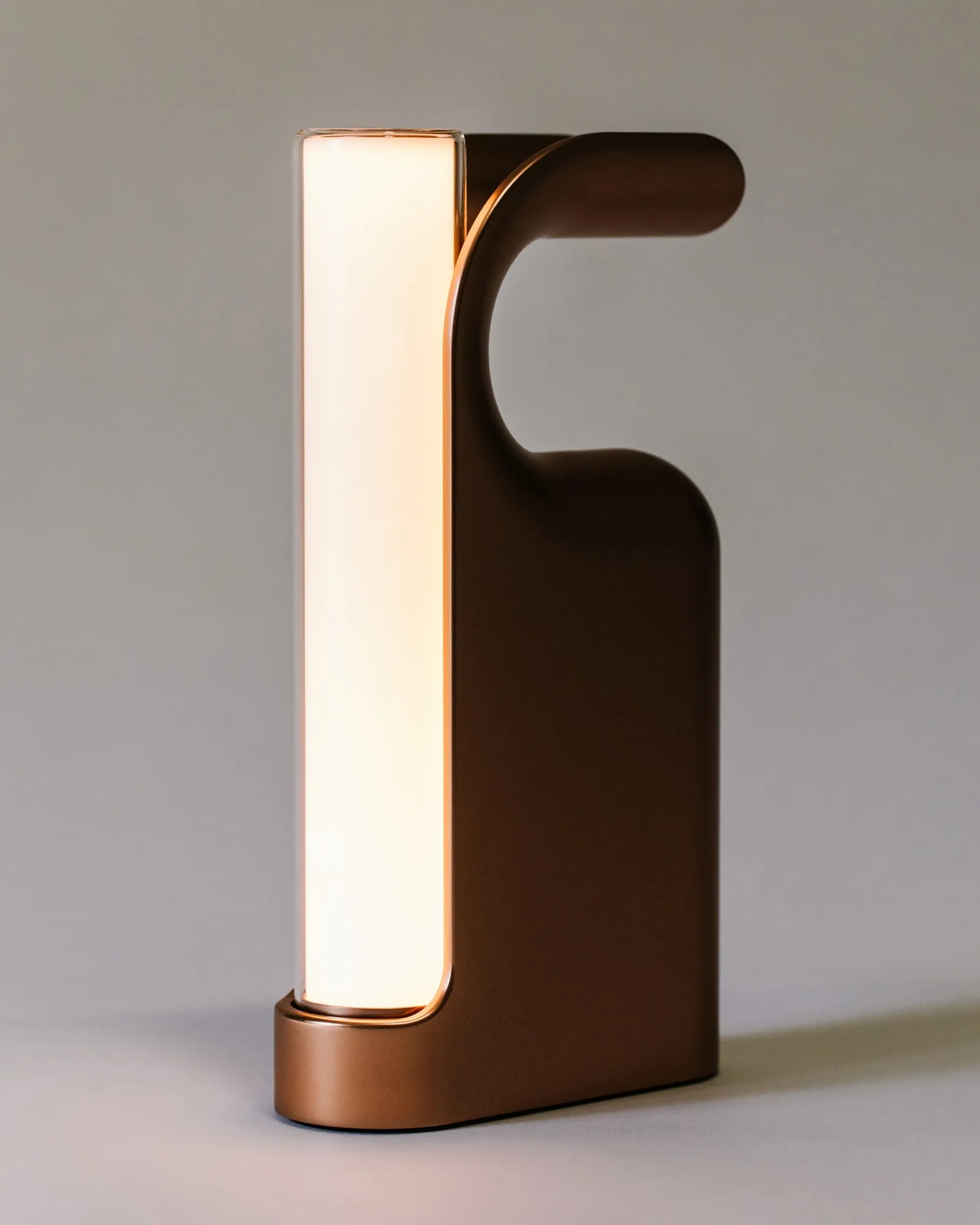 A Fable Lantern in bronze, its glass panel lit