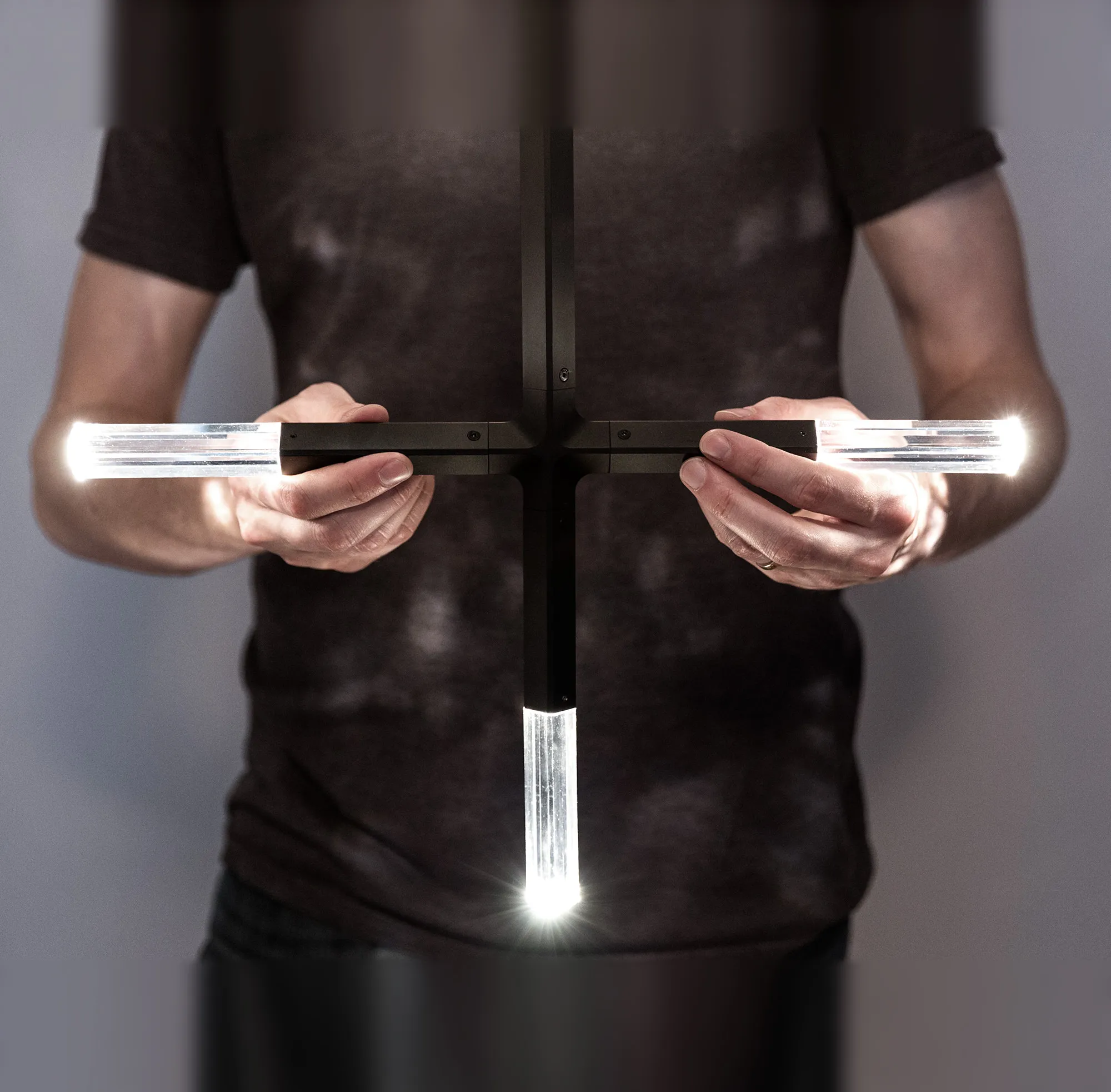 JAX Edition fixture held in two hands, lit